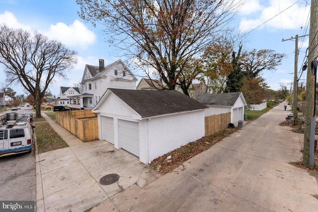 view of home's exterior featuring a garage and an outbuilding