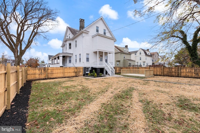 back of property featuring a yard