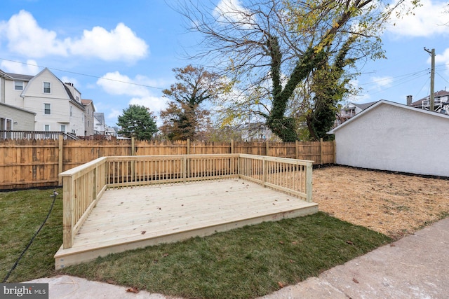 wooden deck featuring a yard