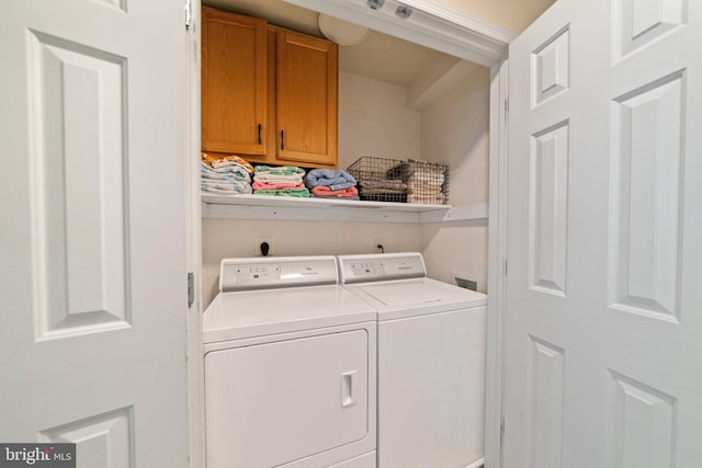 laundry area with cabinet space and independent washer and dryer