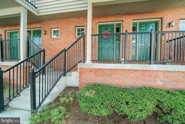 property entrance featuring brick siding