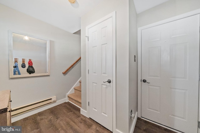 stairway with baseboards, baseboard heating, and wood finished floors