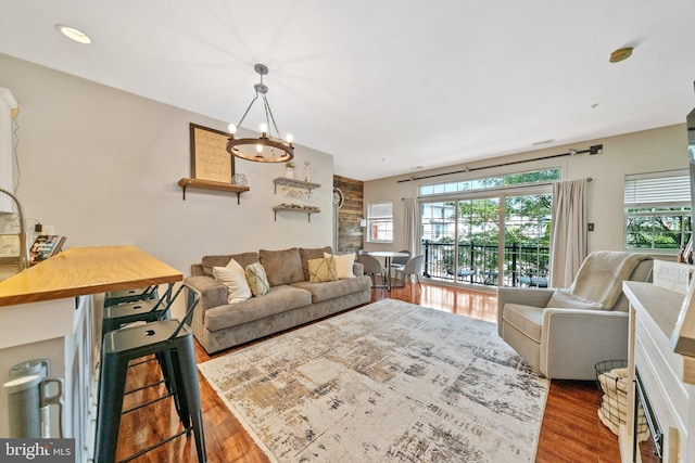 living room featuring an inviting chandelier and wood finished floors