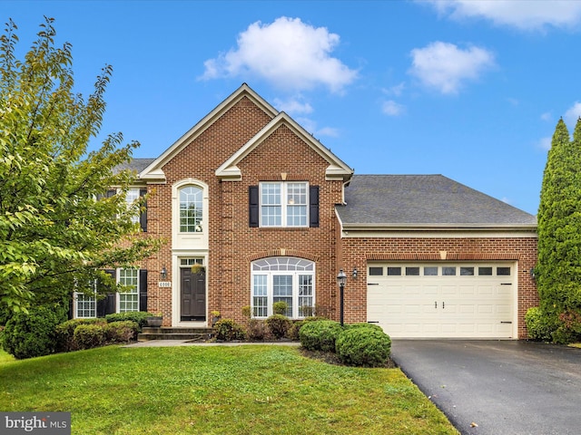 view of front of house featuring a front yard and a garage