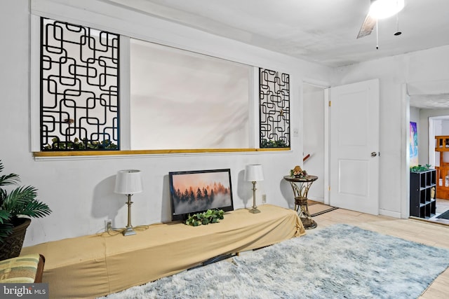 interior space featuring wood-type flooring and ceiling fan