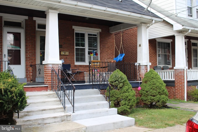 view of exterior entry with a porch