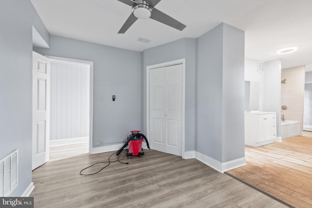 playroom with baseboards, visible vents, and light wood-style floors