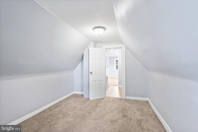 bonus room featuring baseboards, carpet floors, and lofted ceiling