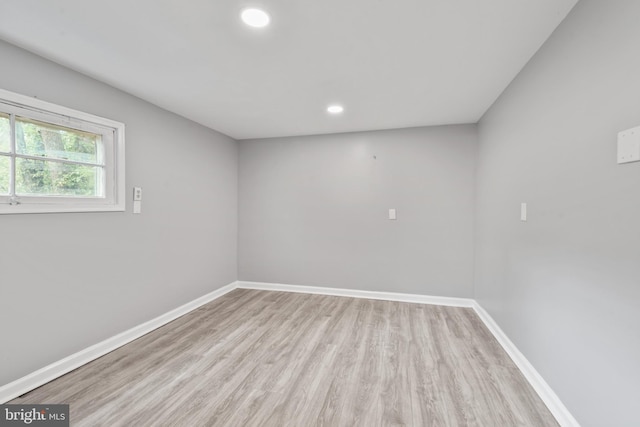 empty room with recessed lighting, baseboards, and wood finished floors