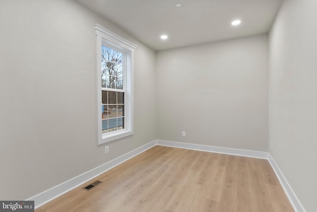 spare room with light wood-style flooring, baseboards, and recessed lighting