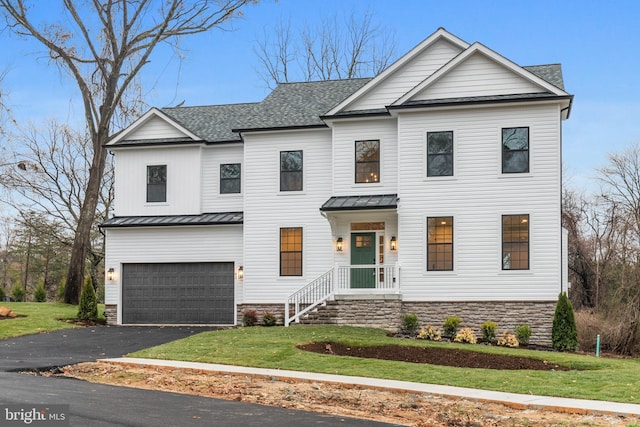 modern farmhouse with a garage and a front yard