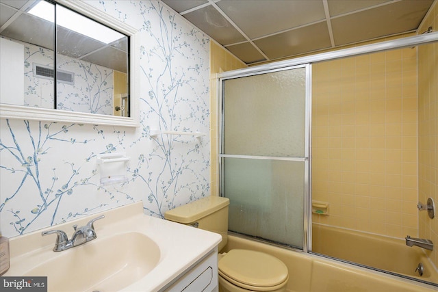 bathroom with wallpapered walls, toilet, visible vents, and shower / bath combination with glass door