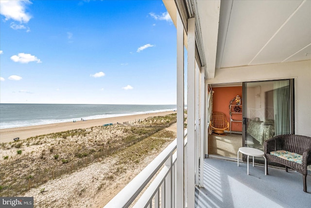 balcony with a view of the beach and a water view