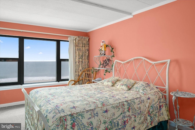 carpeted bedroom featuring baseboards and crown molding