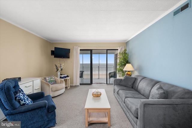 living room with carpet, visible vents, and crown molding