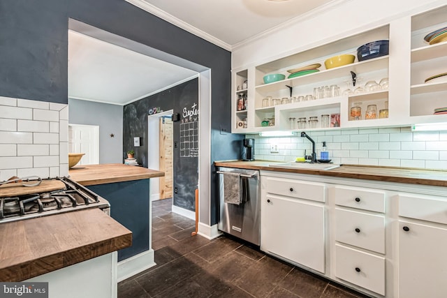 kitchen with white cabinets, backsplash, butcher block countertops, stainless steel appliances, and sink