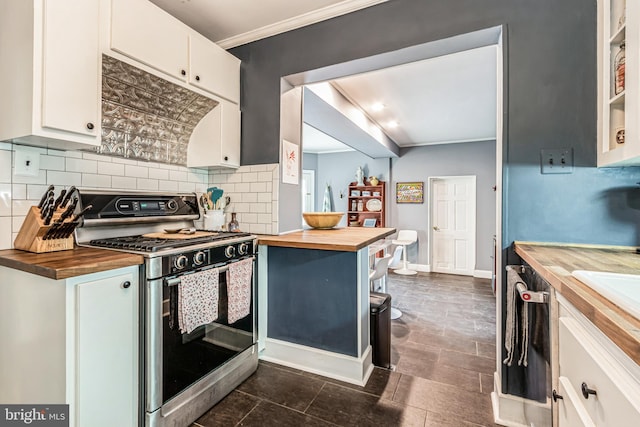 kitchen with decorative backsplash, white cabinetry, butcher block countertops, stainless steel appliances, and ornamental molding