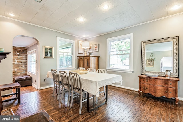 dining space featuring dark hardwood / wood-style floors and crown molding