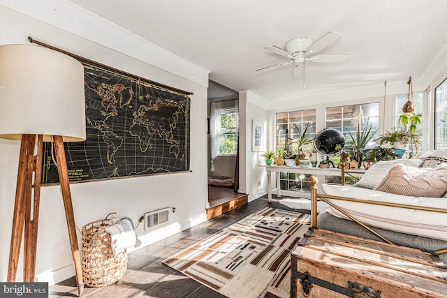 sunroom featuring ceiling fan