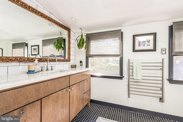 bathroom with radiator, tile patterned floors, and vanity