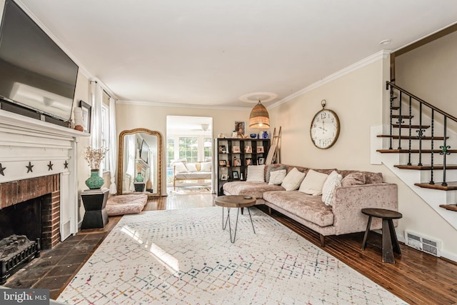 living room featuring a fireplace, ornamental molding, and dark wood-type flooring