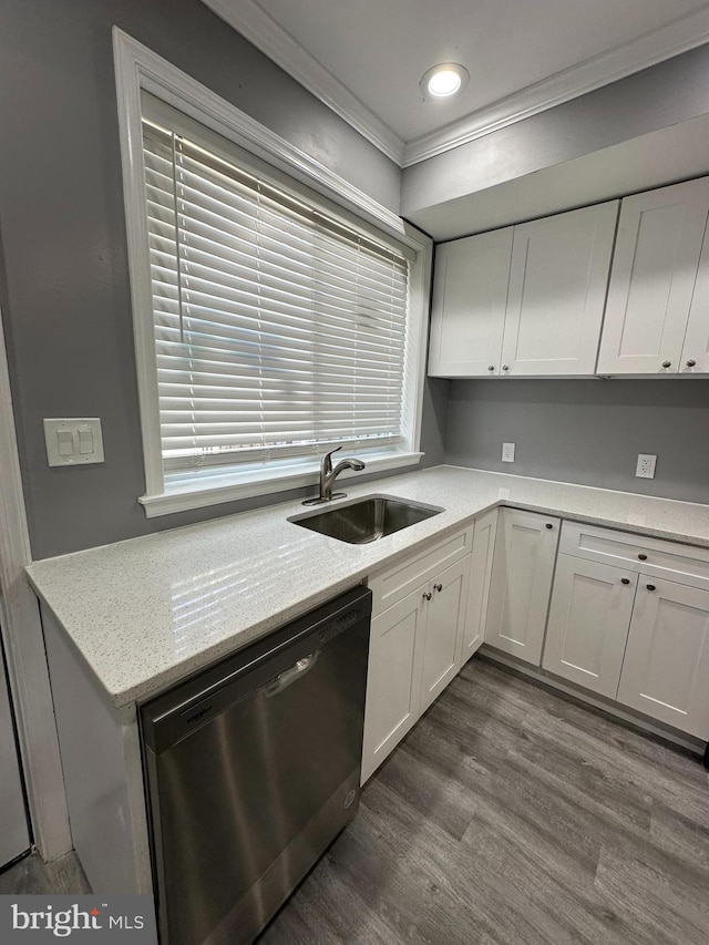 kitchen with ornamental molding, stainless steel dishwasher, sink, and white cabinets