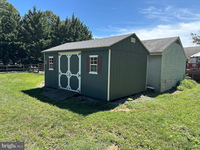 view of shed with fence