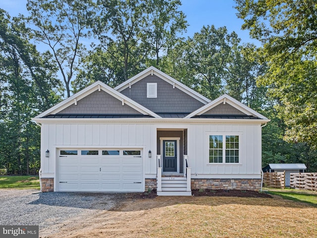 craftsman-style home featuring a garage, a front yard, and covered porch