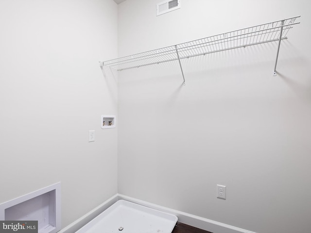 clothes washing area featuring hookup for a washing machine, laundry area, visible vents, and baseboards