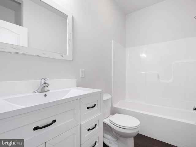 full bathroom featuring washtub / shower combination, vanity, toilet, and wood finished floors