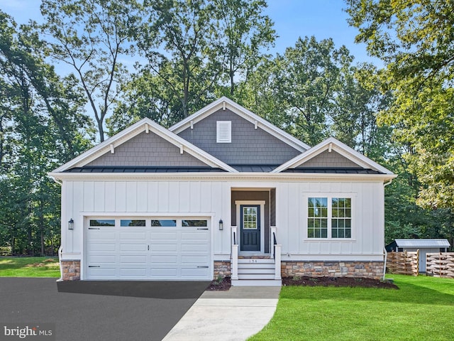 view of front of home featuring board and batten siding, a front yard, a standing seam roof, and an attached garage