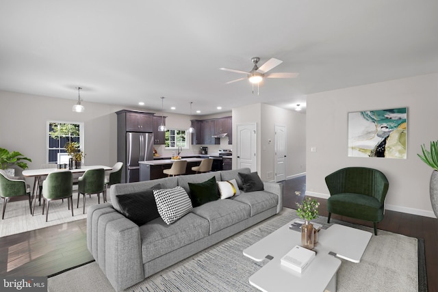 living room featuring recessed lighting, ceiling fan, baseboards, and wood finished floors