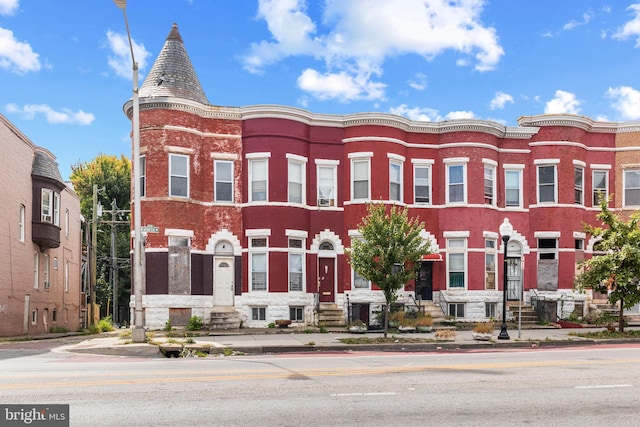 view of front of property featuring entry steps and brick siding