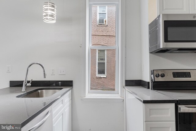 kitchen featuring white cabinetry, appliances with stainless steel finishes, and a sink