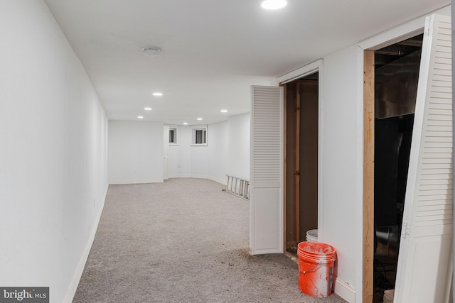 interior space featuring baseboards, recessed lighting, and light colored carpet