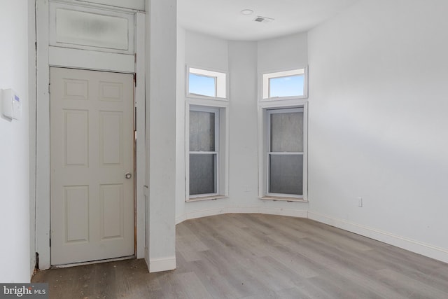 entrance foyer with visible vents, baseboards, and wood finished floors