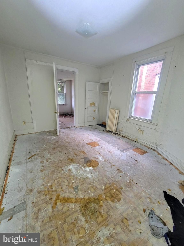 unfurnished bedroom featuring radiator