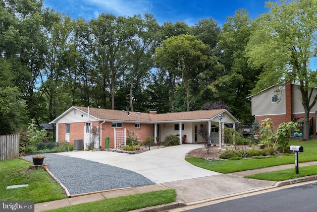 ranch-style house featuring central AC unit and a front lawn