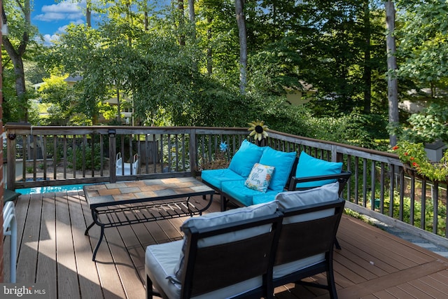 wooden deck with an outdoor living space