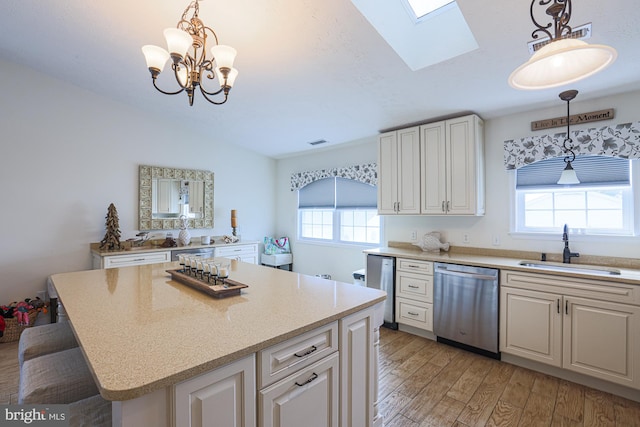 kitchen featuring light hardwood / wood-style floors, dishwasher, a healthy amount of sunlight, and a center island