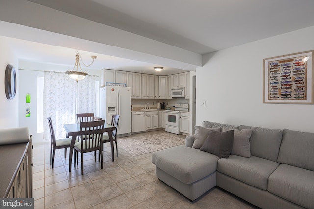 tiled living room featuring an inviting chandelier and sink