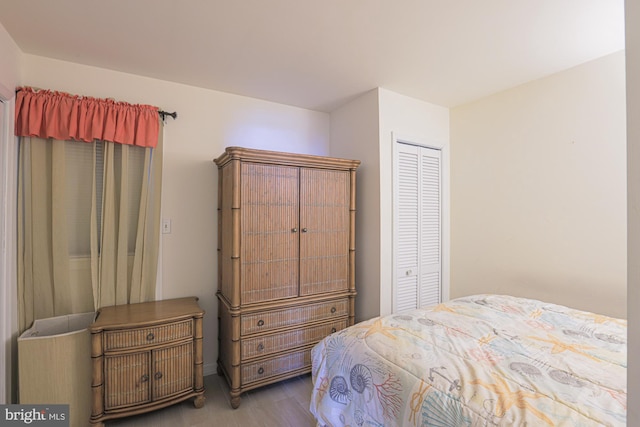 bedroom with a closet and hardwood / wood-style flooring