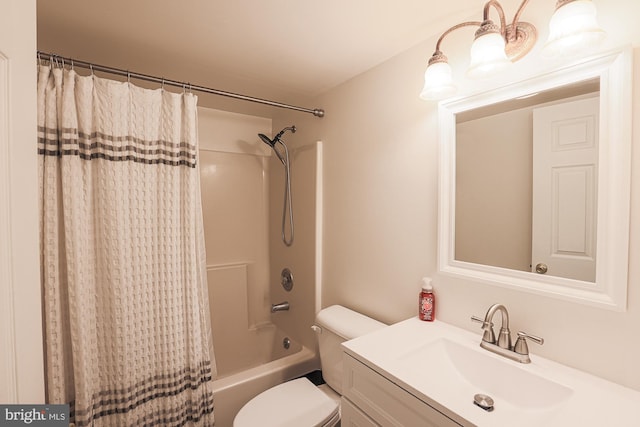 full bathroom featuring vanity, shower / bath combo with shower curtain, and toilet