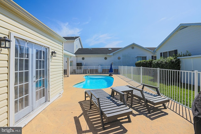 view of swimming pool with a patio and a lawn