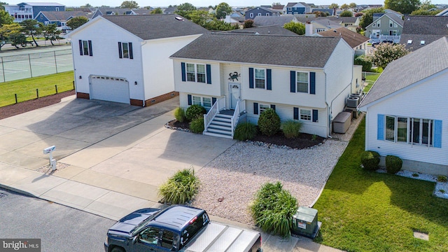 split foyer home featuring a front yard and a garage