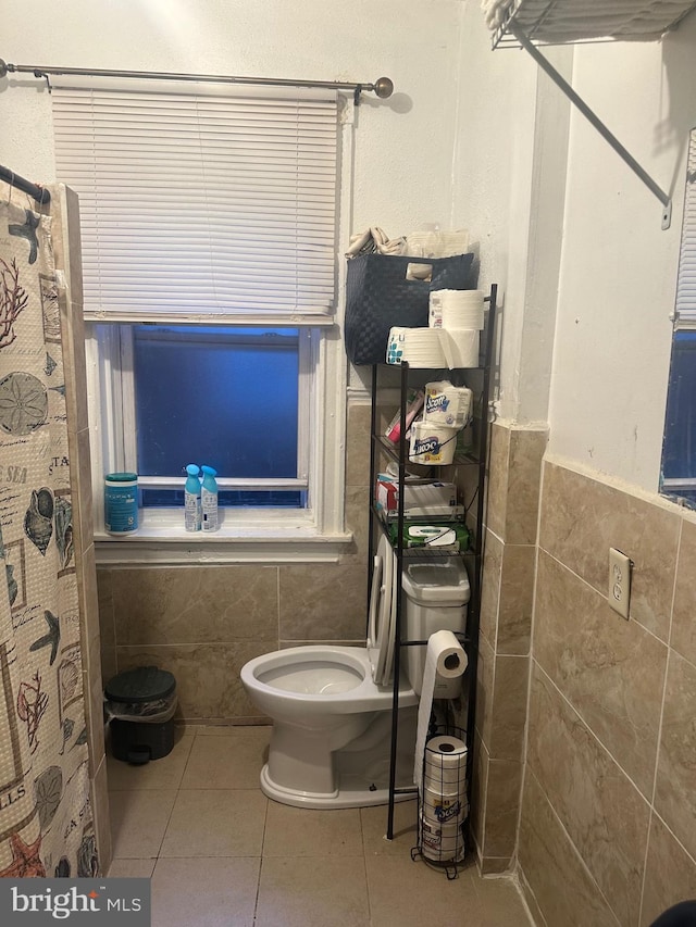 bathroom featuring tile walls, a shower with curtain, toilet, and tile patterned flooring