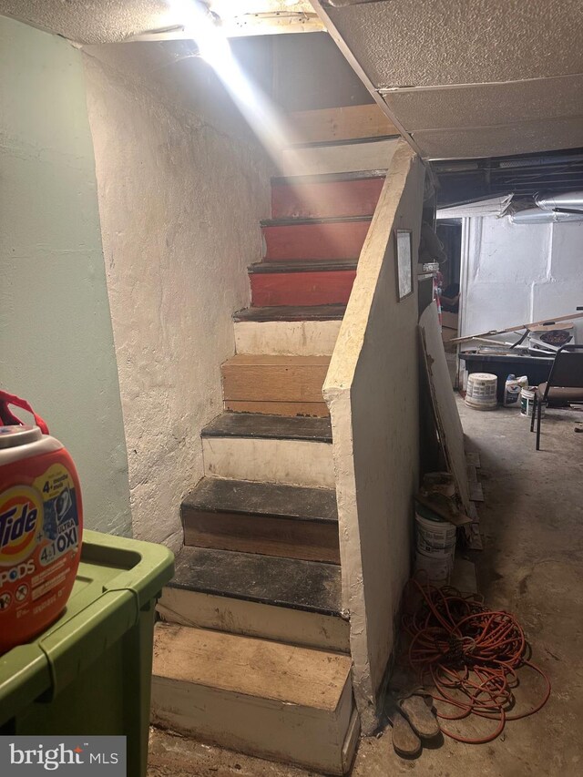 stairway with a textured ceiling