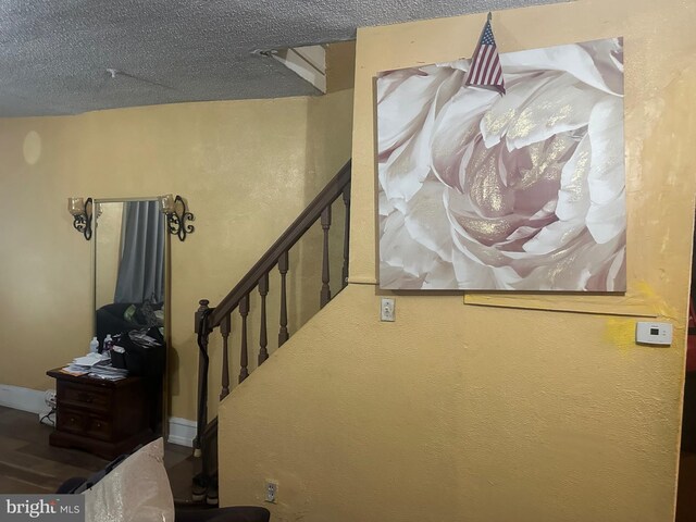 stairway with a textured ceiling