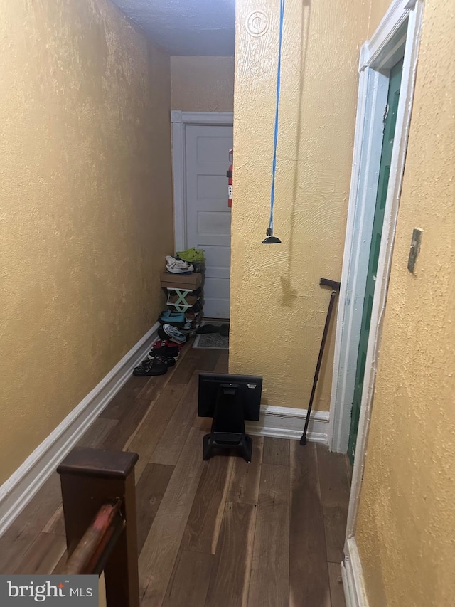 corridor featuring dark hardwood / wood-style flooring