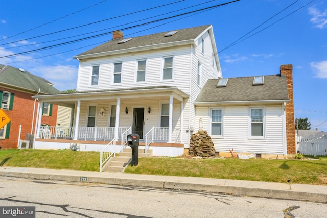 view of front of house with covered porch and a front yard